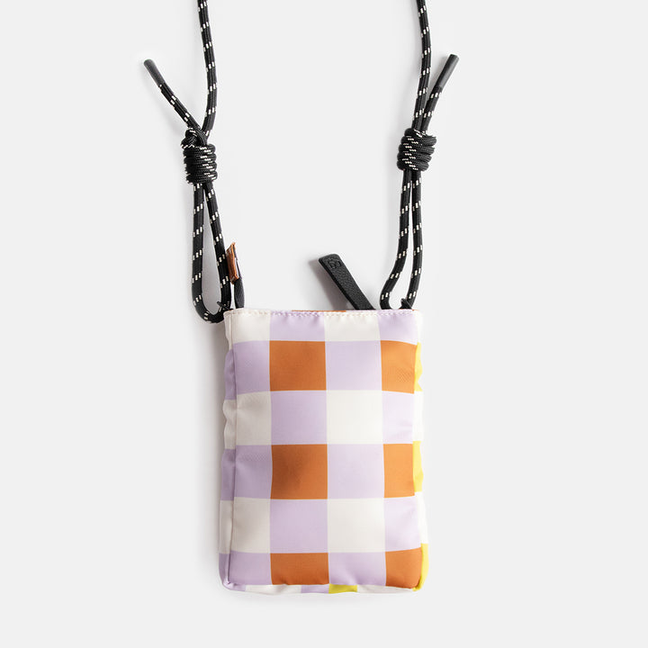 nylon padded phone bag in warm tones check design, with a monochrome adjustable cord strap and black zip pull