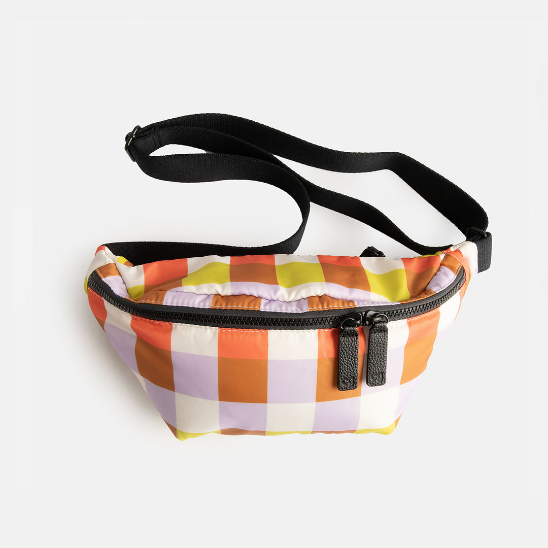 warm tones check nylon crossbody bag with black zip and straps and monochrome spot print lining