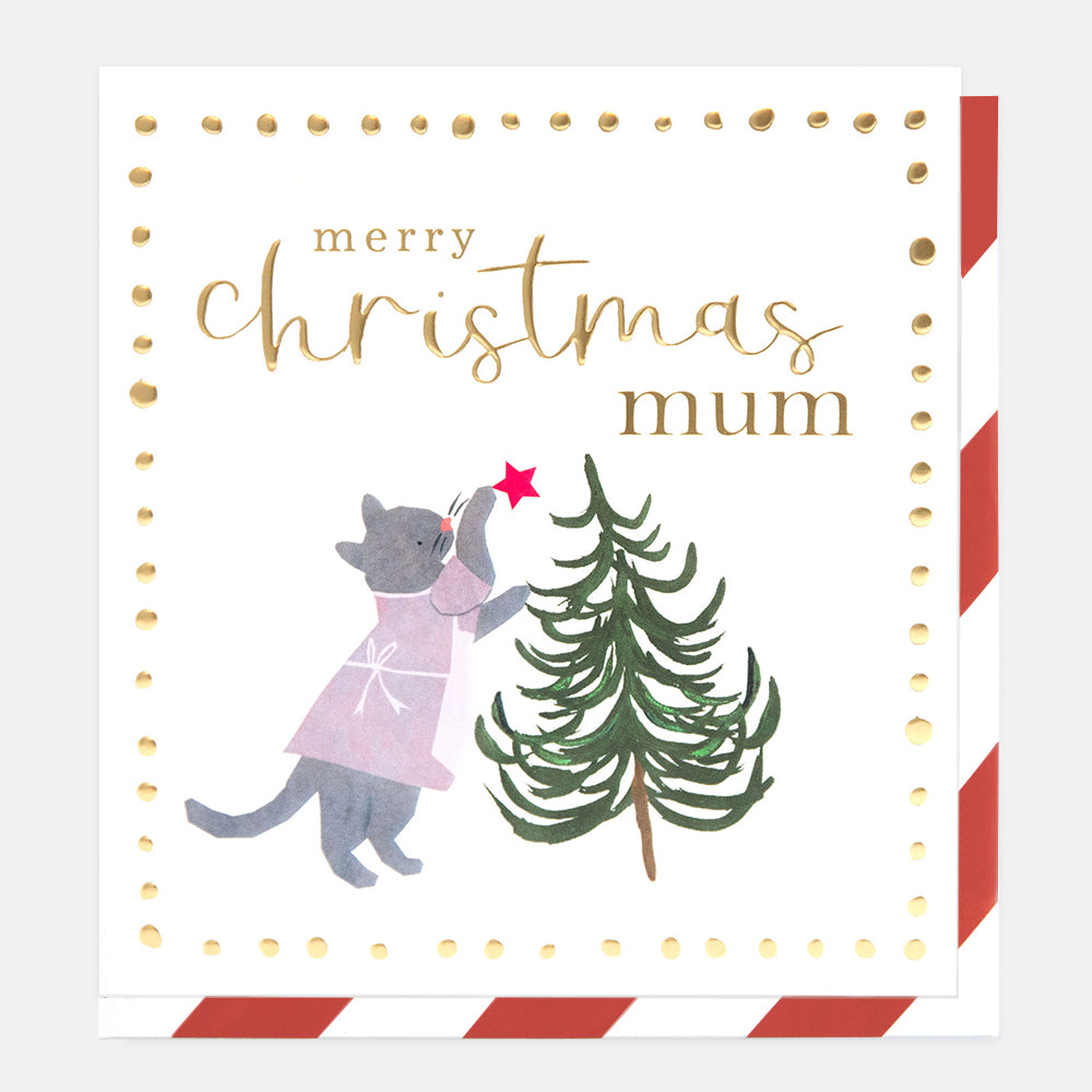 A square Christmas greeting card with a white background, gold dotted border, and the text 'merry christmas mum' in gold script. The illustration shows a gray cat in a pink dress reaching for a red star on a green Christmas tree.