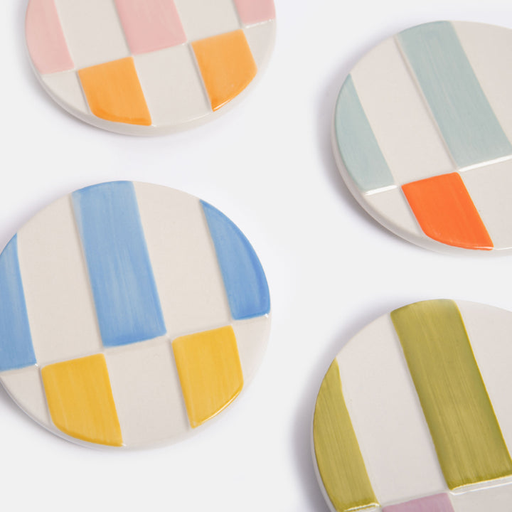 hand painted ceramic stoneware coasters with colourful raised stripe designs and anti slip silicone feet