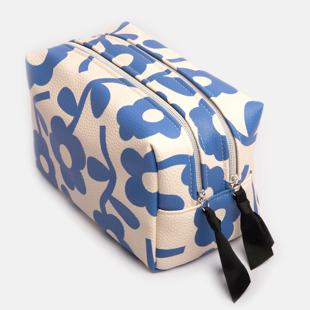 leather look PU large travel wash bag in blue floral design, with double zip opening, grab handle, heart print lining and grosgrain zip pull