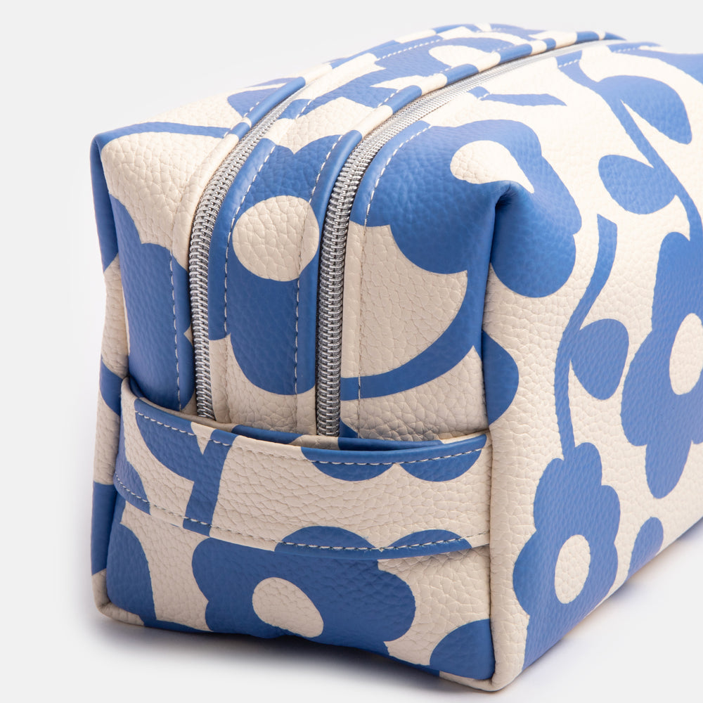 leather look PU large travel wash bag in blue floral design, with double zip opening, grab handle, heart print lining and grosgrain zip pull