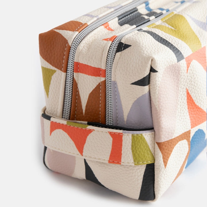 leather look PU large travel wash bag in multicoloured hearts design, with double silver zip opening, side grab handle, grey stripe print lining and black grosgrain zip pull