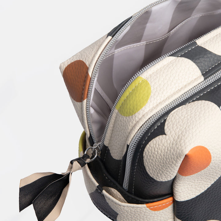 large travel wash bag in leather look PU with white flower design on charcoal base and light grey striped lining