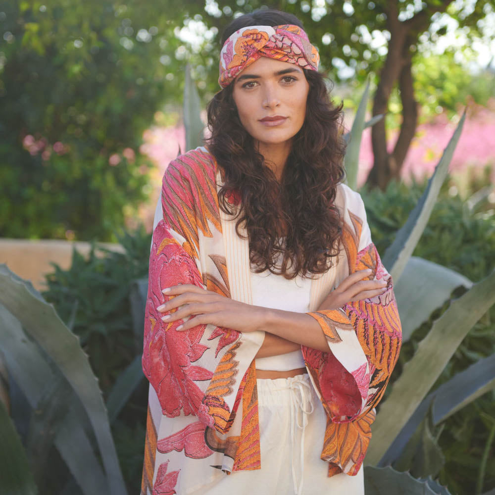 woman wearing pink & orange cranes print on ecru base short kimono jacket, made by On Hundred Stars