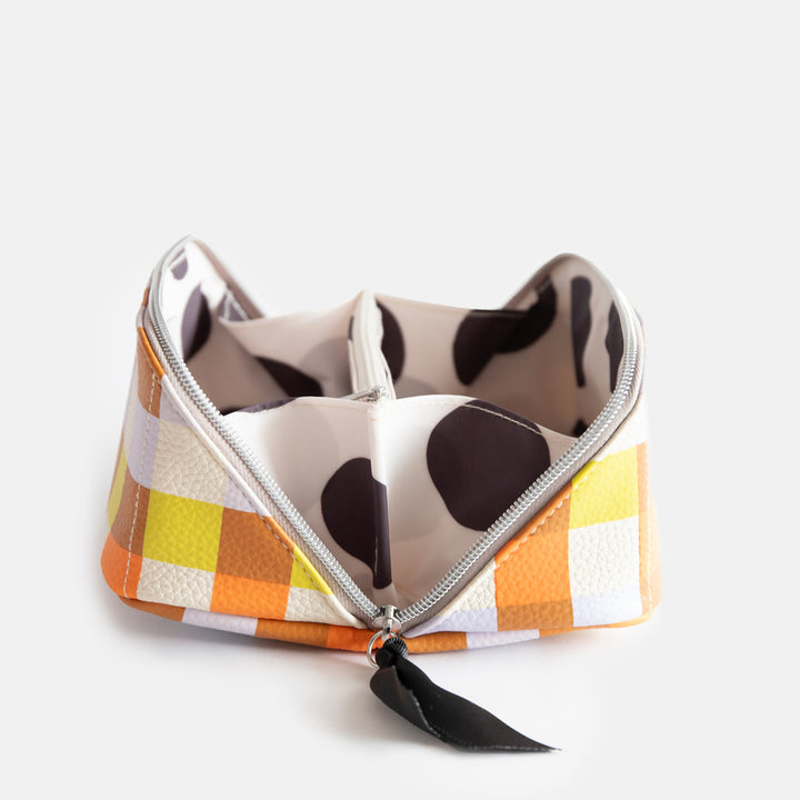 leather look PU lay flat cosmetics bag in warm tones check print with spotty wipe clean lining, silver zip and black grosgrain pull