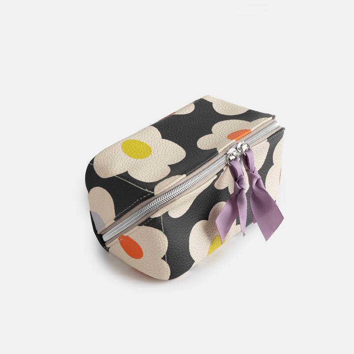 leather look PU lay flat cosmetics bag in multi flower charcoal design with striped wipe clean lining, silver zip and lilac grosgrain pull
