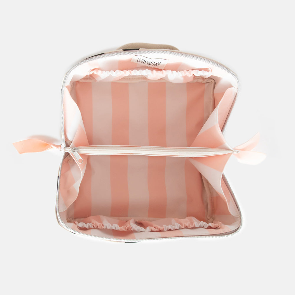 diagonal zip flat lay vegan leather wash bag in monochrome spots with soft pink striped lining and inner zipped pocket