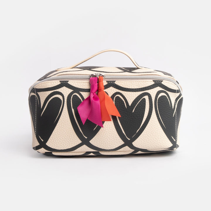 diagonal zip flat lay wash bag with monochrome looped hearts design and contrast orange & pink fabric zip pulls