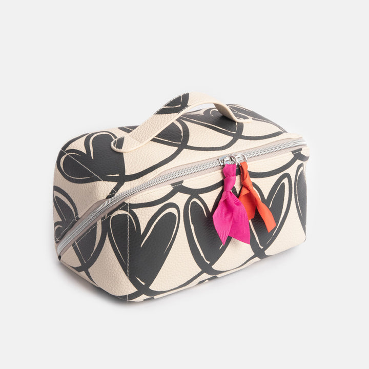 diagonal zip flat lay wash bag with monochrome looped hearts design and contrast orange & pink fabric zip pulls