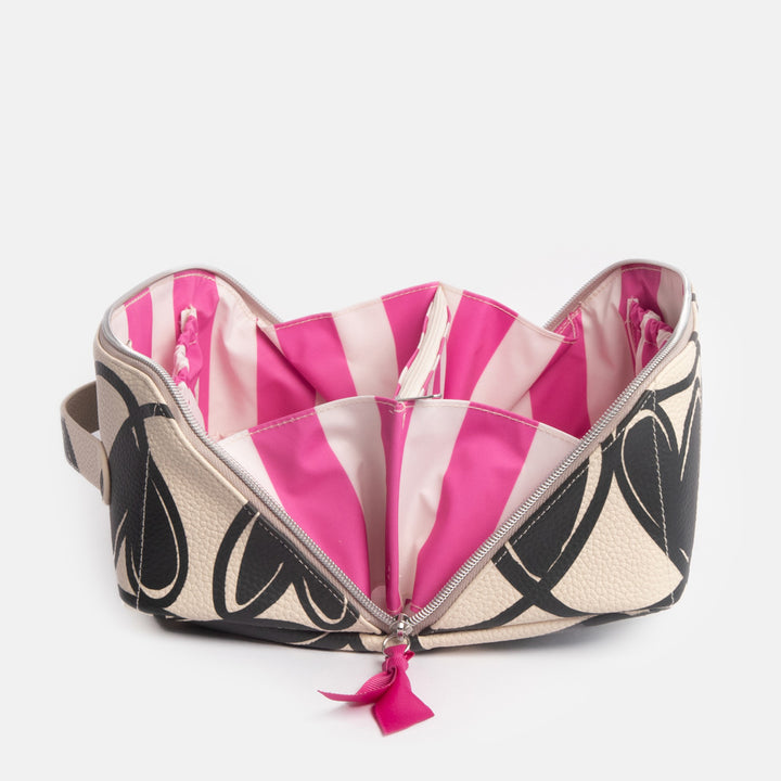 diagonal zip flat lay wash bag with monochrome looped hearts design and contrast bright pink stripe internal lining