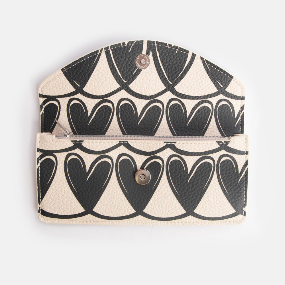 long envelope purse with monochrome looped hearts design, zipped internal pocket and popper overflap closure