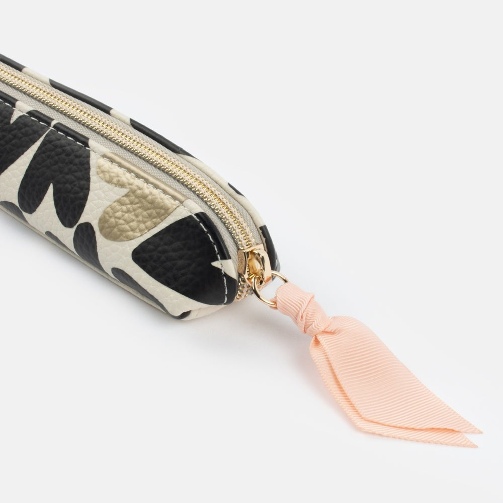 black and white monochrome hearts print leather look pencil case with gold hardware and pink ribbon zip pull