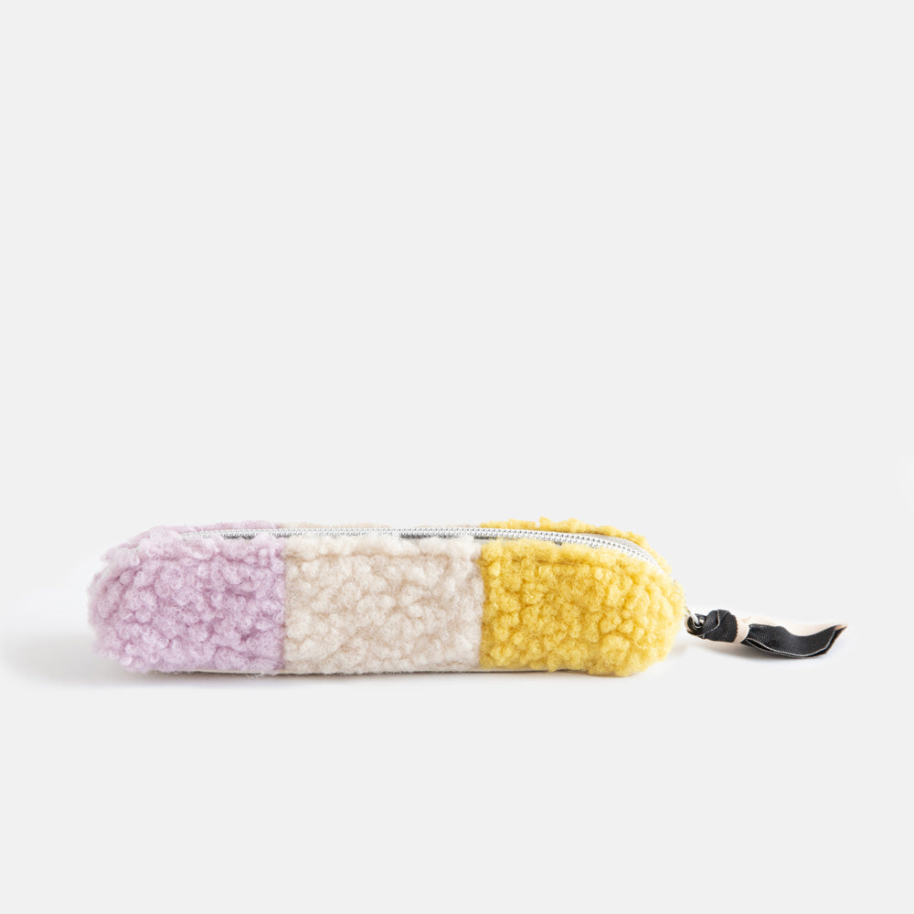 synthetic borg slim pencil case in cream, yellow and lilac with a black and white zip pull and big spots lining