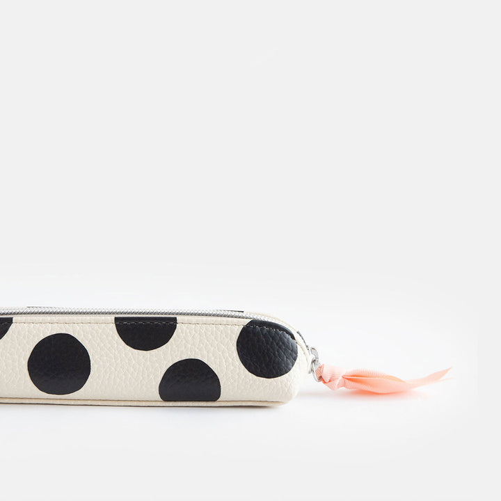leather look PU slim pencil case in a big black spots design with a pink ribbon zip pull and striped lining