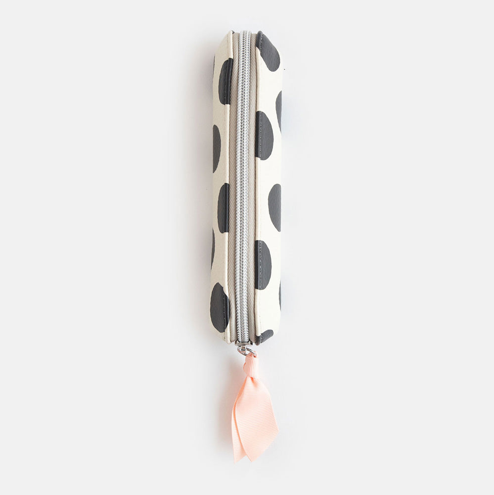 leather look PU slim pencil case in a big black spots design with a pink ribbon zip pull and striped lining
