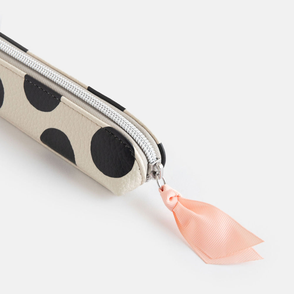 leather look PU slim pencil case in a big black spots design with a pink ribbon zip pull and striped lining