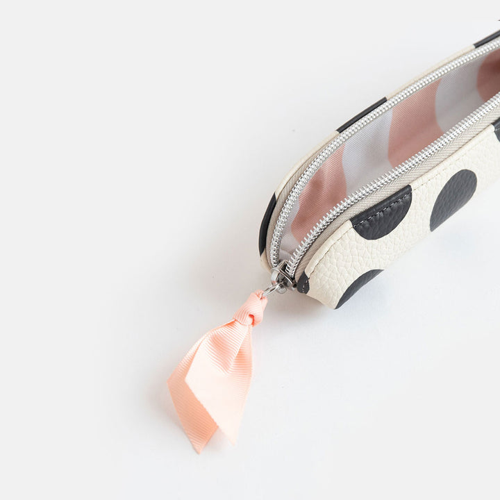 leather look PU slim pencil case in a big black spots design with a pink ribbon zip pull and striped lining
