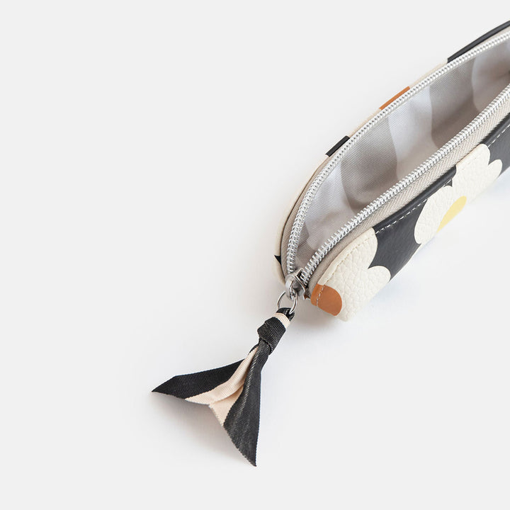 leather look PU slim pencil case in a cream flowers on charcoal background design with a black and white ribbon zip pull and grey striped lining