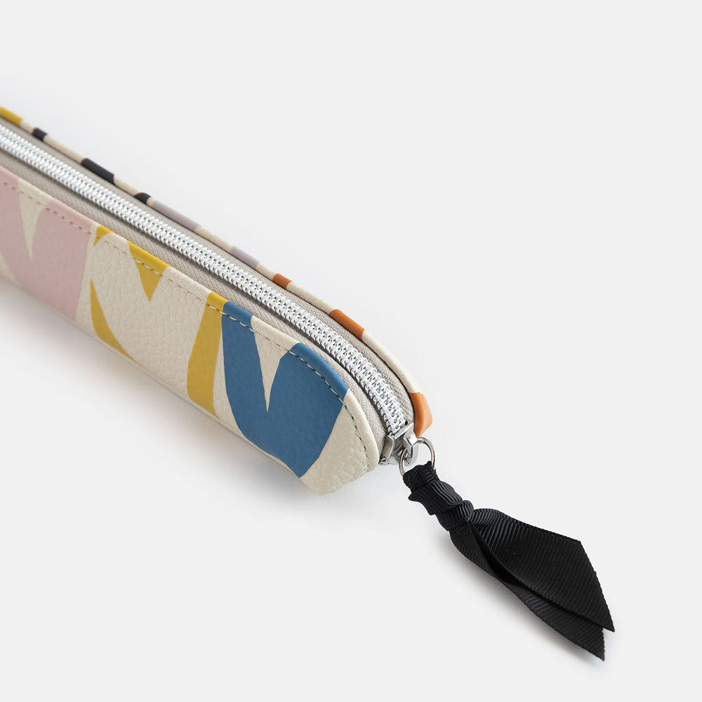 leather look PU slim pencil case in a multicolour hearts design with a black ribbon zip pull and pink striped lining