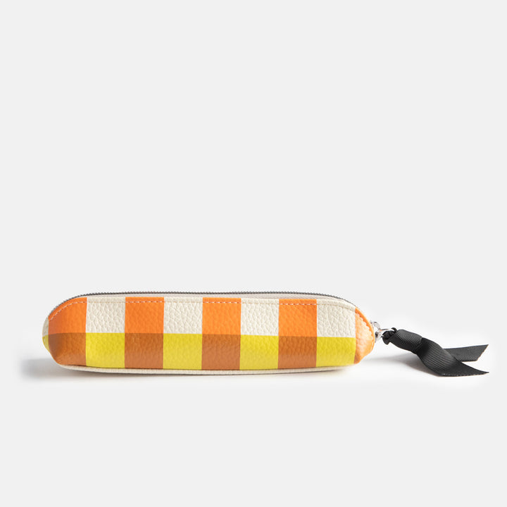 leather look PU slim pencil case in a warm tones check design with a black ribbon zip pull