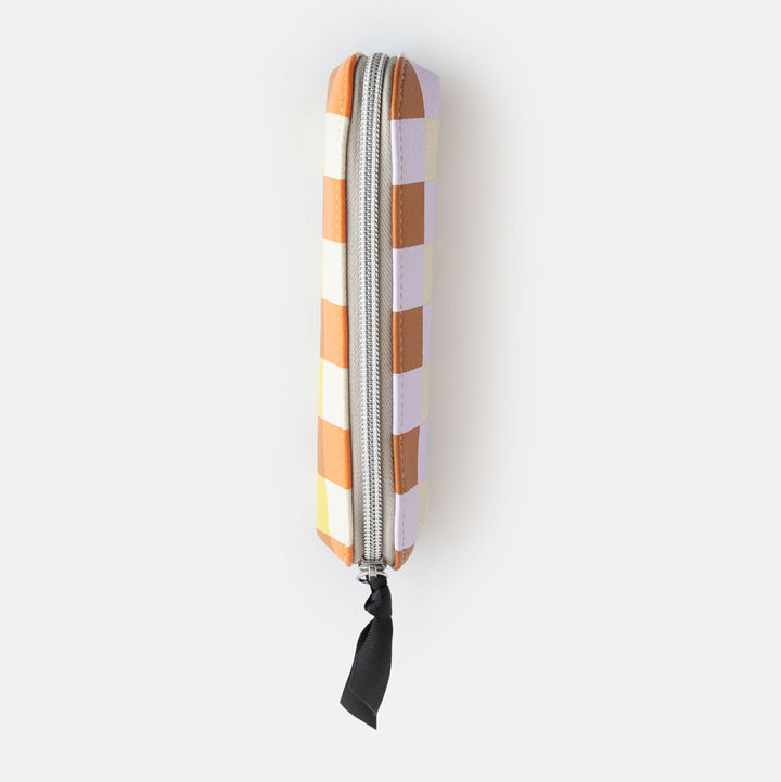 leather look PU slim pencil case in a warm tones check design with a black ribbon zip pull