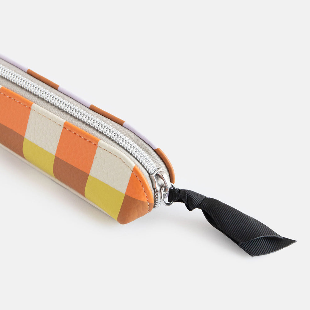 leather look PU slim pencil case in a warm tones check design with a black ribbon zip pull