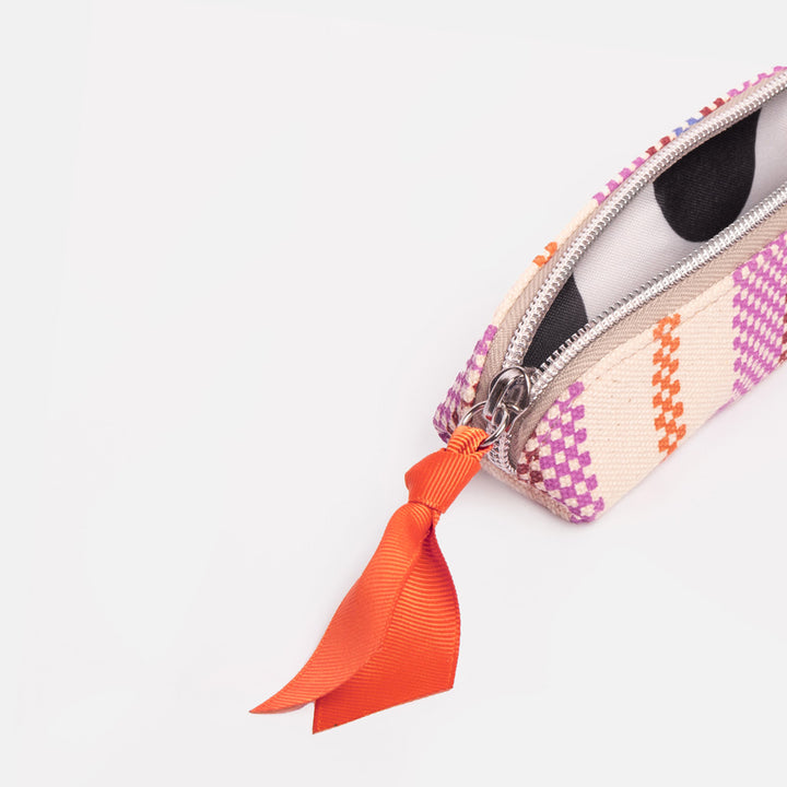 canvas pencil case with colourful checkerboard stripe design and monochrome spot lining