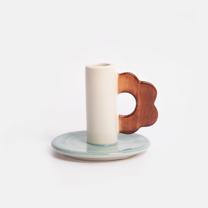ceramic candle holder with light blue base and brown flower shaped loop handle