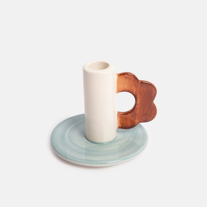 ceramic candle holder with light blue base and brown flower shaped loop handle