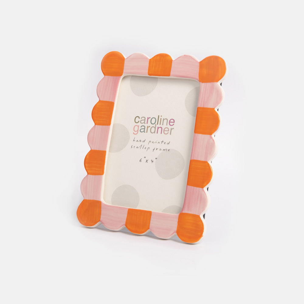 Decorative photo frame with orange and pink scalloped design on a white background