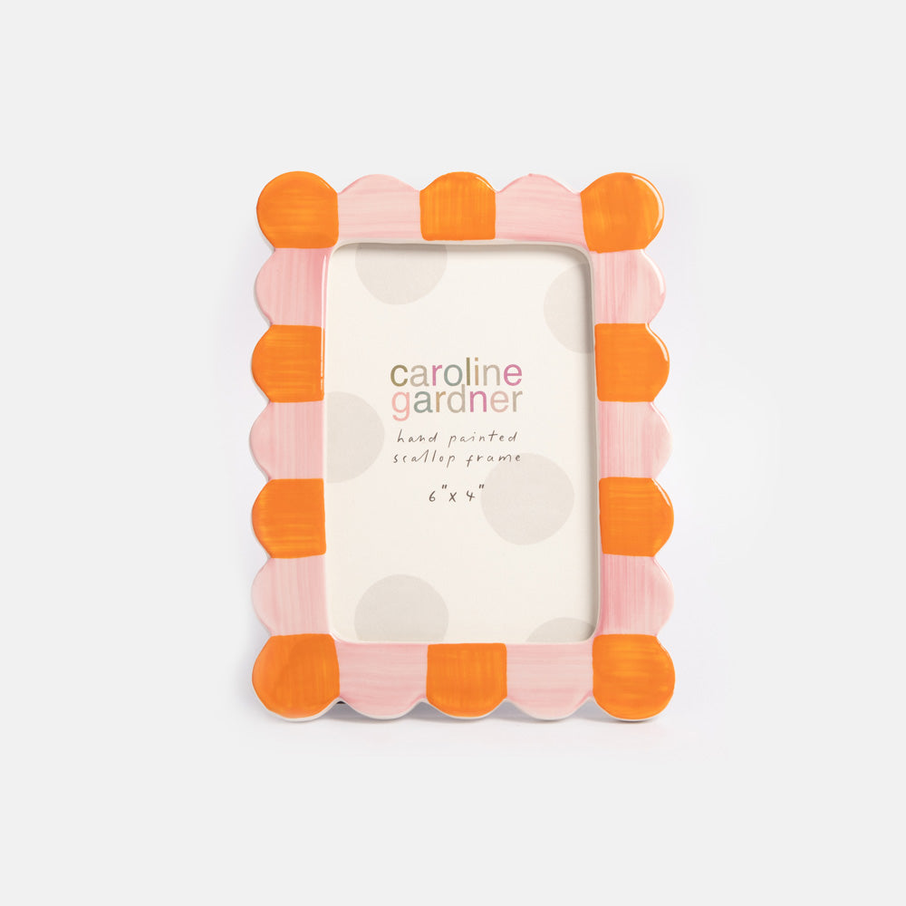 Decorative photo frame with orange and pink scalloped design on a white background