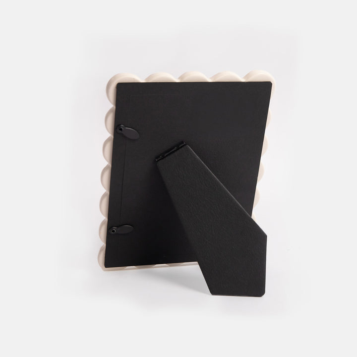 reverse of photo frame showing black free standing stand