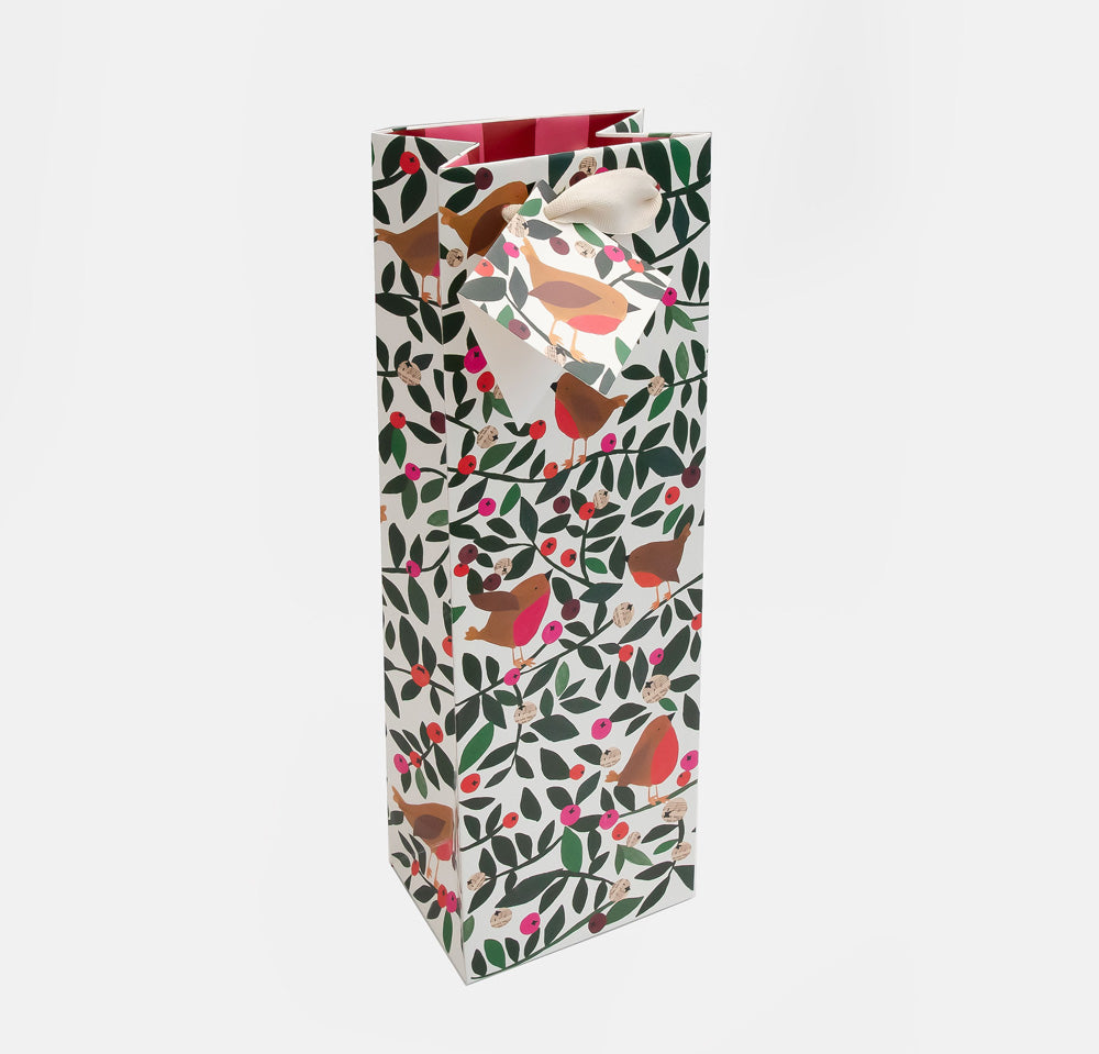 A tall gift bag with a festive robin and berry pattern, featuring a cream ribbon bow on a light gray background.