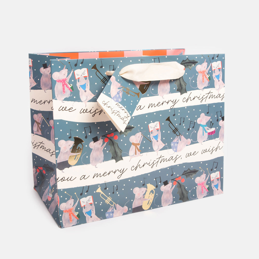 Gift bag with Christmas-themed design featuring musical mice with instruments on a blue background