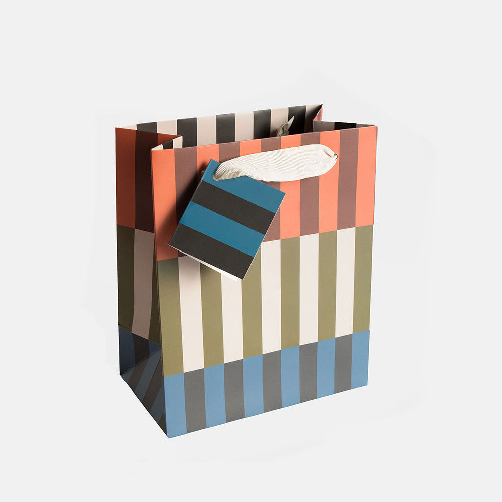 medium gift bag in colourful geometric stipe design in orange, brown, green and blue