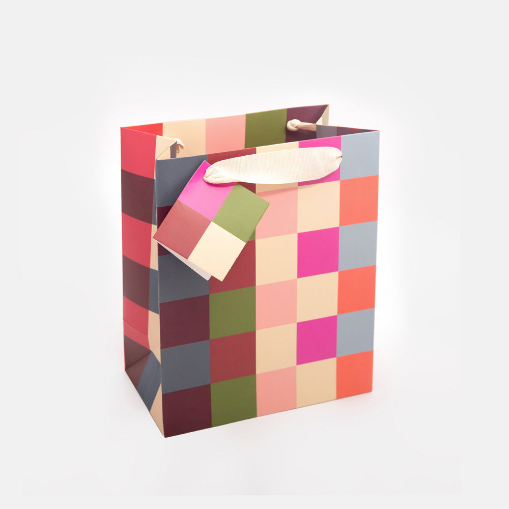 medium gift bag featuring a colourful geometric check design and matching gift tag