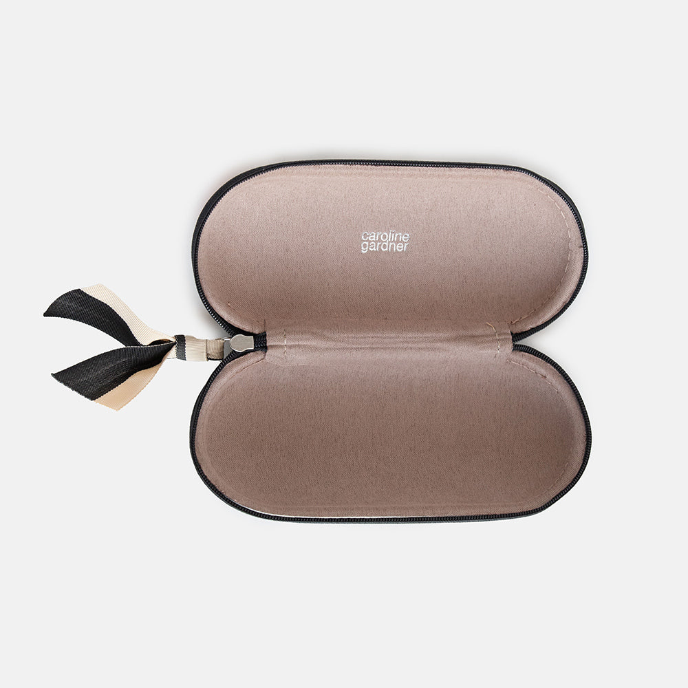 leather look hard glasses case in colourful flowers print with suedette lining and black and white ribbon zip pull