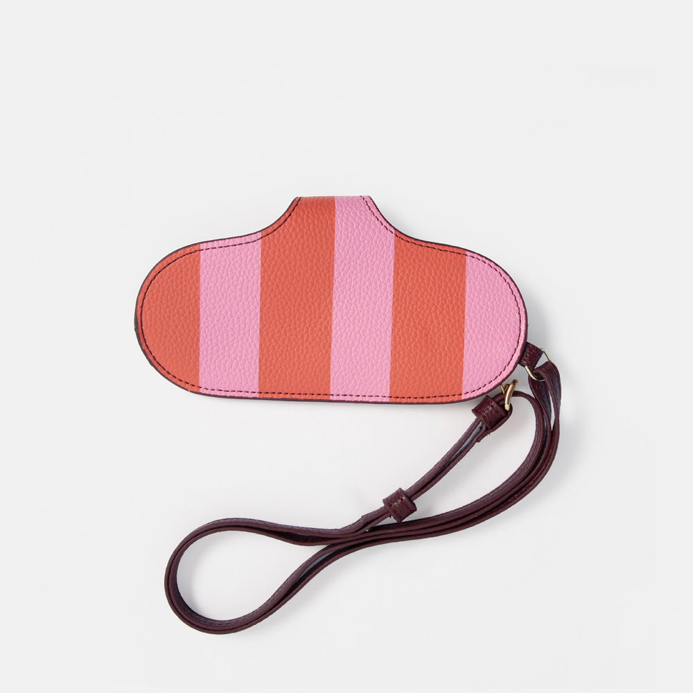 A cloud-shaped glasses case with vertical pink and coral-orange stripes, featuring a dark brown faux-leather wrist strap, shown on a plain white background.