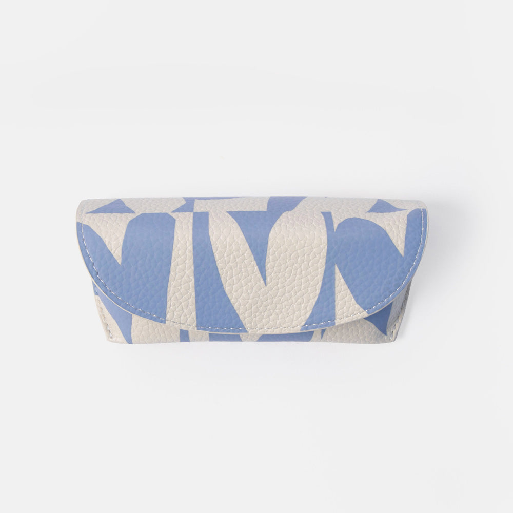 A small pebbled leather glasses case with a blue and off-white geometric pattern, shown on a light gray background.