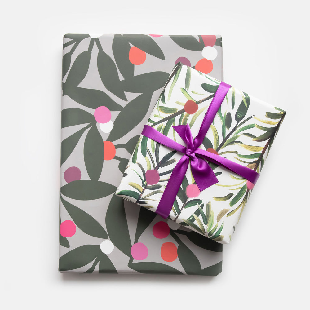 Two wrapped gifts with floral patterns and ribbons on a white background