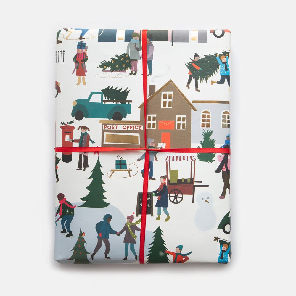 Gift wrap with Christmas scene design featuring people, trees, and a post office.