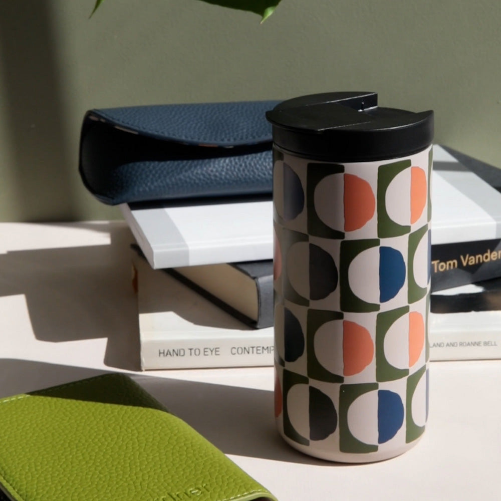 stainless steel travel mug in retro geometric circles design in green, blue and orange
