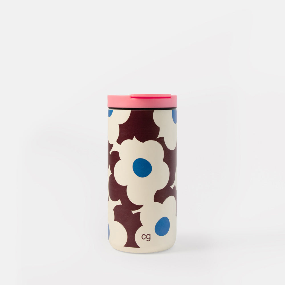 A travel mug with a retro floral pattern in cream, dark brown, and blue, featuring a bright pink lid, on a clean white background.