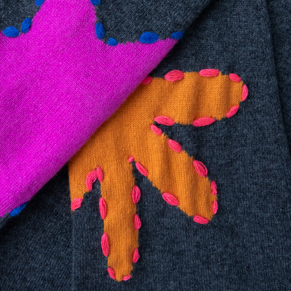 grey crew neck pure cashmere jumper with intarsia embroidered orange and pink shapes on elbows, made by Cocoa cashmere