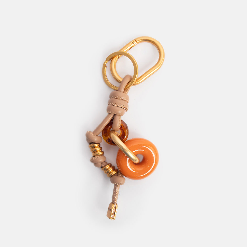 bag charm, or large keyring, featuring 2 resin rings in orange & tortoiseshell, and knotted leather and gold hardware strap
