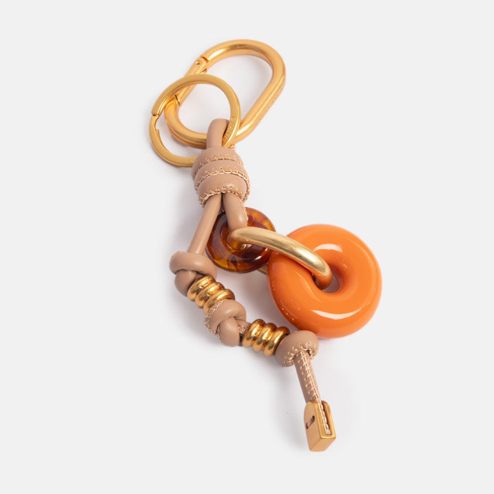 bag charm, or large keyring, featuring 2 resin rings in orange & tortoiseshell, and knotted leather and gold hardware strap