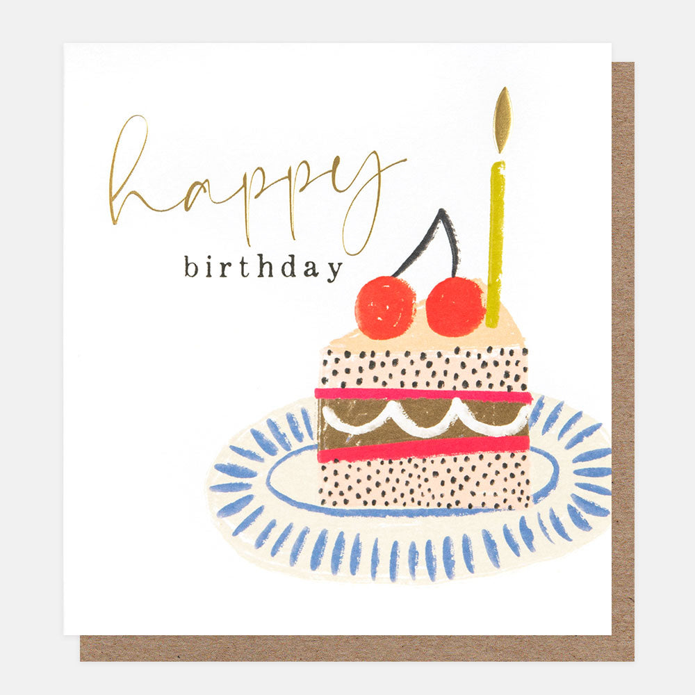 slice of cake on a plate with a candle happy birthday card
