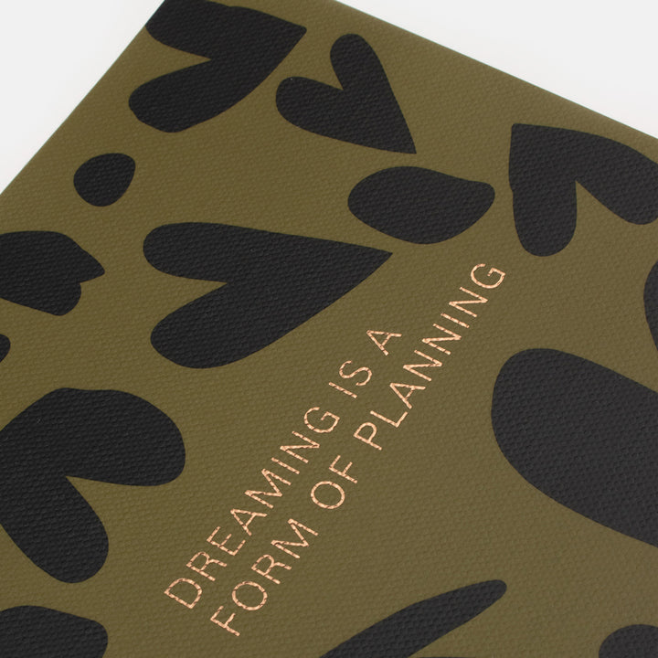 khaki and black hearts print life planner slogan on front saying dreaming is a form of planning