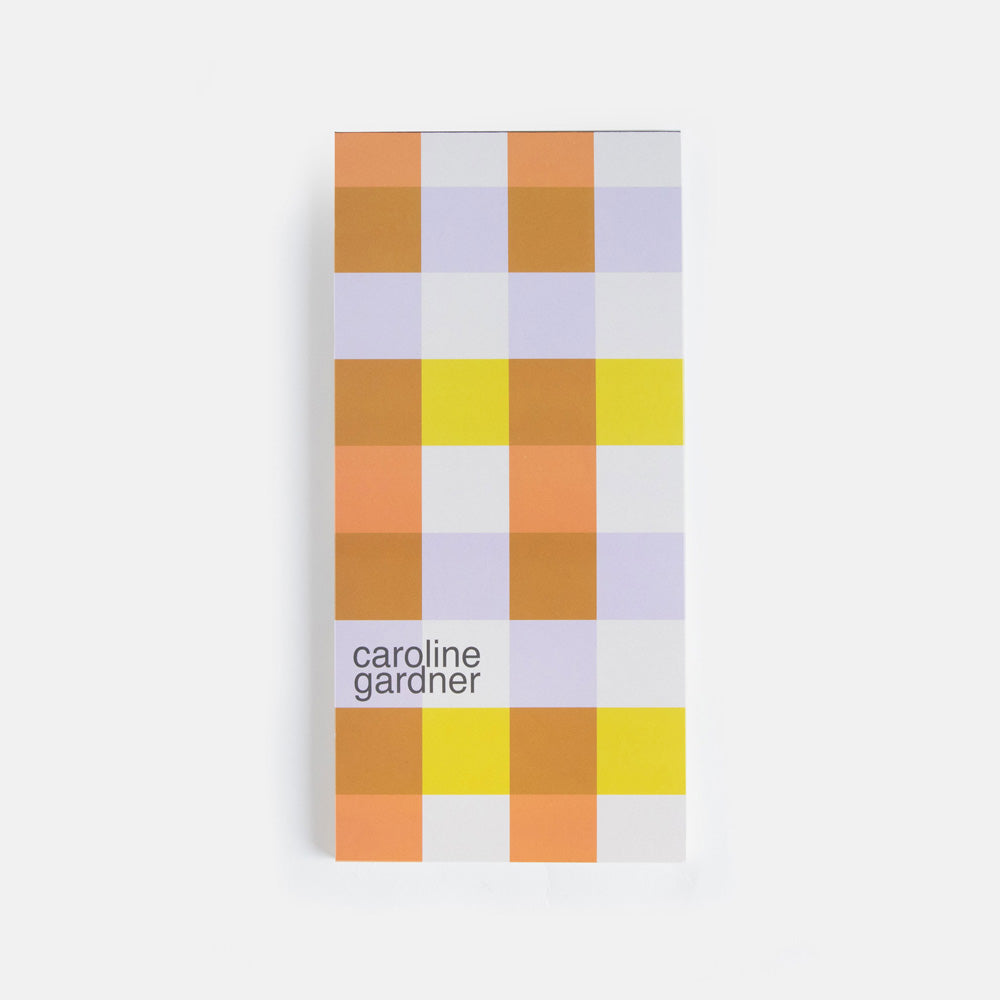 lined list pad with big flower print and a multi coloured checked print backing